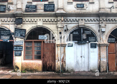 KANDY, SRI LANKA - DECEMBER 2017: Historic walls with lots of signs for attorneys and notaries in the center of Kandy in Sri Lanka Stock Photo