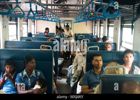 KANDY, SRI LANKA - DECEMBER 2017: People traveling in third class in the train between Kandy and Ella in Sri Lanka Stock Photo