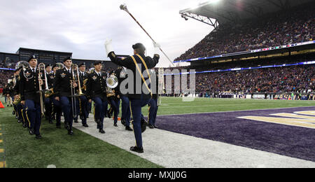 JOINT BASE LEWIS-MCCHOROD, Wash. – Soldiers from the I Corps Band march off the field after performing alongside the University of Washington Marching Band prior to the Washington Huskies and USC Trojans football game in Seattle Nov. 12. The I Corps Band performed both America the Beautiful and the Star Spangled Banner as part of UW’s Salute to Service. (U.S. Army photos by Staff Sgt. Steven Schneider, 5th MPAD) Stock Photo