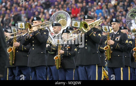 JOINT BASE LEWIS-MCCHOROD, Wash. – Soldiers from the I Corps Band perform America the Beautiful alongside the University of Washington Marching Band prior to the Washington Huskies and USC Trojans football game in Seattle Nov. 12. The I Corps Band performed both America the Beautiful and the Star Spangled Banner as part of UW’s Salute to Service. (U.S. Army photos by Staff Sgt. Steven Schneider, 5th MPAD) Stock Photo