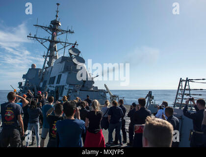 161110-N-SU278-190 PACIFIC OCEAN (Nov. 9, 2016) Sailors assigned to the guided-missile destroyer USS Spruance (DDG 111) and embarked friends and family members aboard during a tiger cruise watch a demonstration of the ship’s close-in weapons system in the Pacific Ocean, Nov. 9, 2016. Spruance and the guided-missile destroyers USS Decatur (DDG 73) and USS Momsen (DDG 92), along with embarked “Warbirds” and “Devilfish” detachments of Helicopter Maritime Strike Squadron (HSM) 49, are finishing up a seven-month deployment in support of maritime security and stability in the Indo-Asia-Pacific as pa Stock Photo