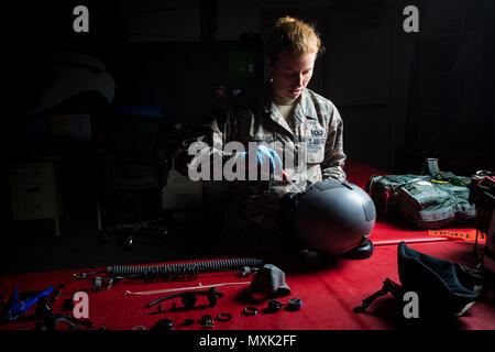 Aircrew Flight Equipment technician Airman 1st Class Kristen, a member of the 380th Air Expeditionary Wing, prepares a high performance helmet for a pilot at an undisclosed location in Southwest Asia, Nov. 11, 2016. “Since Aircrew Flight Equipment directly supports the Pilots and the F-22 aircraft safety features we directly tie into the mission of enabling the F-22's expeditionary war fighting capability,” Kristen said. (U.S. Air Force photo by Senior Airman Tyler Woodward) Stock Photo