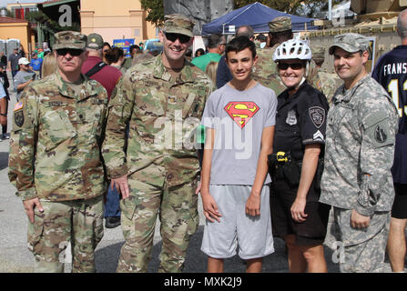 SAN ANTONIO - Local police officer Donna Marti and son Zane pose with soldiers in front of the1st Cavalry static display at the ‘Army vs Irish’ game held at the Alamodome November 12, 2016. As part of the Alamodome static display section, the 1st Calvary provided a M2 Bradley Fighting Vehicle for the public to experience. (Photo by Sgt. Zechariah Gerhard, 345th Public Affairs Detachment) Stock Photo