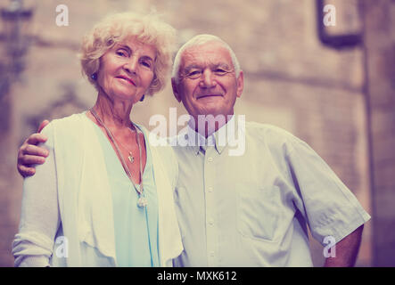 loving mature spouses enjoying walk around European city Stock Photo