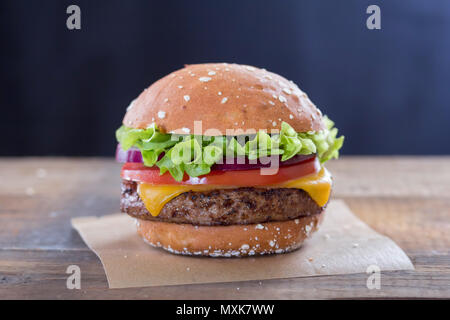 Burger with cheese, lettuce red onion and tomato Stock Photo