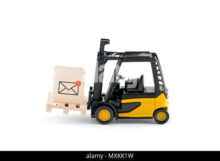 Yellow forklift with new email graphic on wooden block over white background Stock Photo