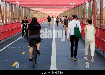 Bicyclists and Pedestrians on the Williamsburg Bridge walkway Stock Photo