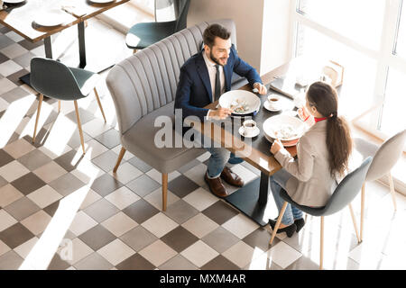 Positive colleagues enjoying lunch time in business cafe Stock Photo