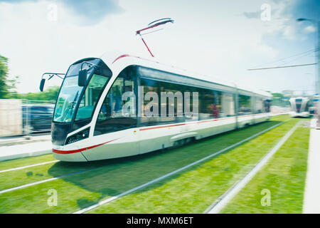 High speed passenger train in motion on railroad. A tram with motion blur effect. Rail transport. Stock Photo