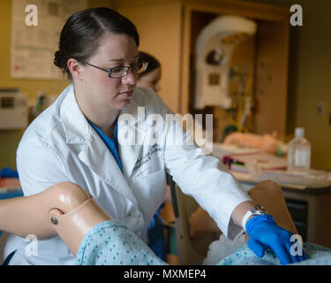 U.S. Navy Lt. Cmdr. Rozalyn Love, an obstetrics and gynaecology (OB/GYN) Staff Physician with U.S. Naval Hospital Guam (USNH Guam), begins postpartum hemorrhage training in the hospital's Mother Baby Unit.  This training, implemented by Military Health System, is intended to prepare physicians, nurses, and Corpsmen for postpartum hemorraging events by teaching them how to quantatively measure bleeding, which helps identify the extent of blood loss and lead to more rapid treatment procedures. (U.S. Navy photo by USNH Guam Public Affairs/Released) Stock Photo