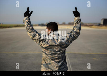Senior Airman from the 51st Civil Engineer Squadron coordinates two teams operating a mobile aircraft arresting system at Osan Air Base, Republic of Korea. The system allows aircraft to stop safely on short runways. The Airman ensures synchronized retraction of the arresting cable while teams maintain situational awareness. This training, part of Prime BEEF exercises, improves runway safety, emergency response capabilities, and base contingency operations. Stock Photo