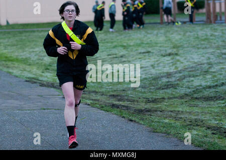 2nd Lt. Jenna Andry, 1st Battalion, 37th Field Artillery Regiment, 2nd Infantry Division Artillery, runs a lap in remembrance of retired Command Sgt. Maj. James “Jim” Steinthal on Rose Field, Joint Base Lewis-McChord, Wash., Nov. 18, 2016. The battalion held a two-week run-a-thon in honor of the late honorary regimental CSM. (U.S. Army photo by Sgt. Eliverto V Larios) Stock Photo