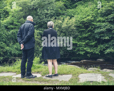 An elderly couple enjoying their retirement in nature Stock Photo