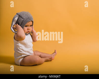 A cute little baby is wearing a bunny hat Stock Photo