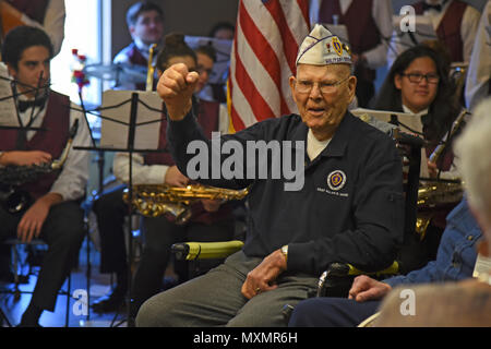 Retired Staff Sgt. Allen G. Wood, United States Army, celebrates during a Veterans Day celebration Nov. 12, 2016, at Spokane Veterans Home. Wood was honored by the Combat Veterans Motorcycle Association for his years of service in the U.S. Army with the presentation of a handmade shadow box displaying medals received during the time of Wood’s service.  (U.S. Air Force photo/Senior Airman Mackenzie Richardson) Stock Photo