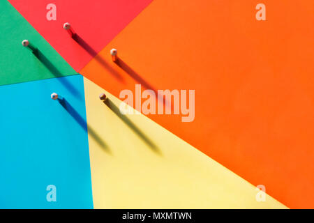 Five different colored pencils on a multicolored background, light shadow on the background .A horizontal and graphic composition,rainbow effect Stock Photo