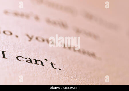 Words I'CAN'T printed on a book paper ,macro photo ,letters out of focus on the background Stock Photo