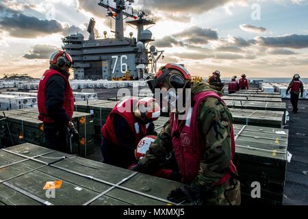 161118-N-OI810-271  PHILIPPINE SEA (Nov. 18, 2016) Sailors prepare ordnance for transport on the flight deck of the USS Ronald Reagan (CVN 76), before an ammunition offload with USNS Charles Drew (T-AKE 10). Ronald Reagan, the Carrier Strike Group (CSG) 5 flagship, is on patrol supporting security and stability in the Indo-Asia-Pacific region. (U.S. Navy photo by Petty Officer 3rd Class Nathan Burke/Released)