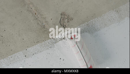 Painting Concrete Ceiling Into White With Roller Stock Photo