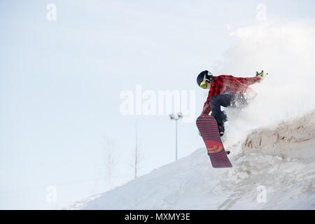 Image of man with snowboard jumping from mountain slope Stock Photo