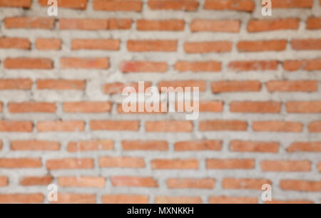 blur image of orange concrete block wall background and texture Stock Photo