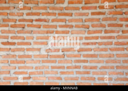 blur image of orange concrete block wall background and texture Stock Photo
