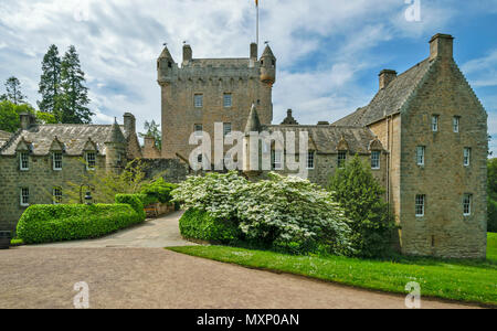 CAWDOR CASTLE NAIRN SCOTLAND THE MAIN BUILDING BRIDGE AND TOWER WITH SHRUB AND WHITE BLOSSOM IN SPRING Stock Photo