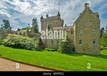 CAWDOR CASTLE NAIRN SCOTLAND THE MAIN BUILDING BRIDGE AND TOWER WITH SHRUB AND WHITE BLOSSOM IN SPRINGTIME Stock Photo