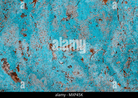 Blue cyan color facade stone wall with imperfections, holes and cracks as an empty rustic and simple texture background. Stock Photo