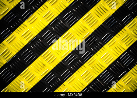 Warning sign yellow and black stripes painted over steel checker plate (or diamond plate) on the floor as texture background. Concept for do not enter Stock Photo