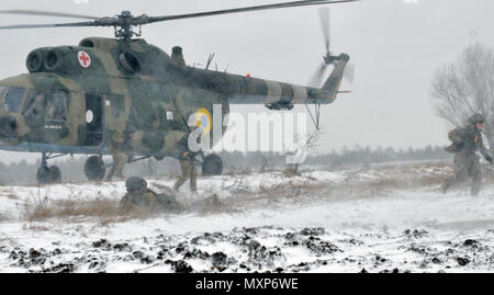 Ukrainian Soldiers assigned to 1st Battalion, 80th Airmobile Brigade dismount from a Mi-8 helicopter for an air assault mission in conjunction with a situational training exercise led by Soldiers from 6th Squadron, 8th Cavalry Regiment, 2nd Infantry Brigade Combat Team, 3rd Infantry Division, Nov. 28, 2016, at the International Peacekeeping and Security Center. This training is part of their 55-day rotation with the Joint Multinational Training Group-Ukraine. JMTG-U is focused on helping to develop an enduring and sustainable training capacity within Ukraine.  (U.S. Army photo by Staff Sgt. El Stock Photo