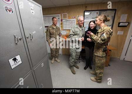 U.S. Air Force Capt. Nicole Ward, right, a flight nurse with the 455th Expeditionary Aeromedical Evacuation Squadron, shares a photo with U.S. Air Force Gen. Paul J. Selva, vice chairman of the Joint Chiefs of Staff, and his wife, Ricki Selva, after meeting with U.S. service members at Bagram Airfield, Afghanistan, Nov. 24, 2016. Gen. Selva and Mrs. Selva visited troops across Afghanistan to spend Thanksgiving Day with them and thank them for their service. (DoD Photo by U.S. Army Sgt. James K. McCann) Stock Photo