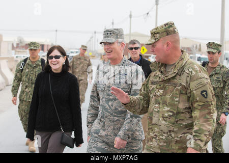 U.S. Army Brig. Gen. Lee Henry, right, Train, Advise and Assist Command – South commander, escorts U.S. Air Force Gen. Paul J. Selva, center, vice chairman of the Joint Chiefs of Staff, and his wife, Ricki Selva, to meet with U.S. service members at Kandahar Airfield, Afghanistan, Nov. 24, 2016. Gen. Selva and Mrs. Selva visited troops across Afghanistan to spend Thanksgiving Day with them and thank them for their service. (DoD Photo by U.S. Army Sgt. James K. McCann) Stock Photo