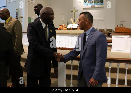 Chairman of the Liberty County Board of Commissioners Donald Lovette (left) greets Col. James Dooghan, commander of 2nd Infantry Brigade Combat Team, 3rd Infantry Division during the 14th annual Mayor’s Thanksgiving Program at First United Methodist Church of Hinesville, Ga., November 20, 2016. Dooghan spoke on behalf of 3rd ID and the community’s military members during the event, whose theme was “Rising from the Storm.” (U.S. Army photo by Staff Sgt. Candace Mundt/Released) Stock Photo