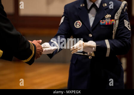 A member of the Yokota Air Base Honor Guard presents a knife to U.S. Army Gen. Vincent K. Brooks, United Nations Command commander, for cake cutting during the United Nations Day 71st Anniversary Celebration in Tokyo, Japan, Nov. 21, 2016. The event was staged by the United Nations Command-Rear, which has been located at Yokota since 2007. (U.S. Air Force photo by Airman 1st Class Donald Hudson/Released) Stock Photo
