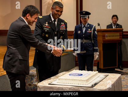 U.S. Army Gen. Vincent K. Brooks, United Nations Command commander, right, and Shunsuke Takei,  Parliamentary Vice-Minister  for Foreign Affairs, left, cut a cake during the United Nations Day 71st Anniversary Celebration in Tokyo, Japan, Nov. 21, 2016. The event was staged by the United Nations Command-Rear, which has been located at Yokota since 2007. (U.S. Air Force photo by Airman 1st Class Donald Hudson/Released) Stock Photo