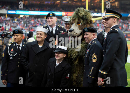 Service members take photos with Staley Da Bear, the Chicago Bears mascot  during the Chicago Bears 'Salute to Service' game Nov. 27 at Soldier Field,  in Chicago. Nearly 100 personnel from all services participated in the  pre-game and halftime show