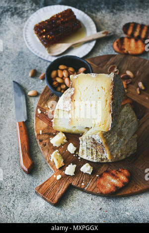 Cheese platter with cheese assortment, nuts, honey and bread Stock Photo