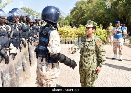 161121-N-XO783-123 DJIBOUTI, Djibouti (Nov. 21, 2016) Commander, U.S. Naval Forces Europe-Africa /Commander, Allied Joint Force Command Naples, Adm. Michelle Howard,  presents a coin to a representative of the Djibouti National Police at the Djibouti National Police Academy Nov. 21, 2016. U.S. Naval Forces Europe-Africa, headquartered in Naples, Italy, oversees joint and naval operations, often in concert with allied, joint, and interagency partners, to enable enduring relationships, and increase vigilance and resilience in Europe and Africa. . (U.S. Navy photo by Petty Officer 2nd Class Adam  Stock Photo