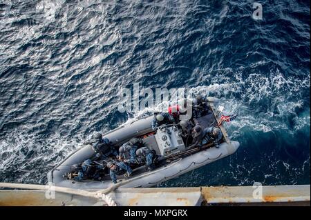 161117-N-UF697-160 SEA OF JAPAN (Nov. 17, 2016) Sailors assigned to the forward-deployed Arleigh Burke-class guided-missile destroyer USS Barry (DDG 52) visit, board, search and seizure (VBSS) team approach the ship in a rigid-hull inflatable boat (RHIB) during a training exercise. Barry is on patrol in the U.S. 7th Fleet area of operations supporting security and stability in the Indo-Asia-Pacific region. (U.S. Navy photo by Petty Officer 2nd Class Kevin V. Cunningham/Released) Stock Photo