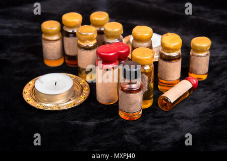 Lot of bottles with a magical potion on a dark background Stock Photo