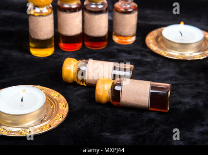 Lot of bottles with a magical potion on a dark background closeup Stock Photo