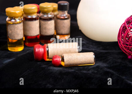 Lot of bottles with a magical potion on a dark background closeup Stock Photo