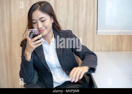 Businesswoman asian using phone for celling and texting on her mobile phone Stock Photo
