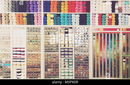 view on sewing shop shelves with various knitting yarn, buttons, threads and other supplies Stock Photo