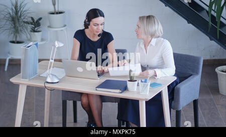 Beautiful female workers working in office Stock Photo