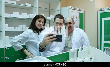 Smiling team of pharmacist taking selfie at hospital pharmacy Stock Photo