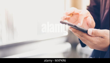 Businessman asian using phone for celling and texting on her mobile phone Stock Photo