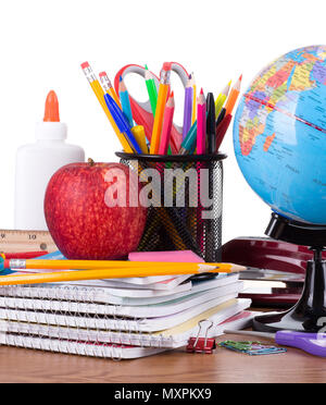 Assortment of school supplies on a wooden desktop and white background Stock Photo