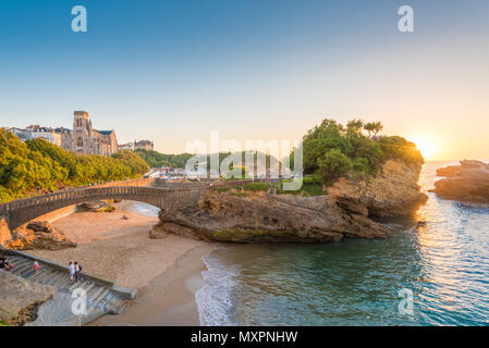 Landscape in Biarritz, France and the sun setting in the horizon over the ocean Stock Photo